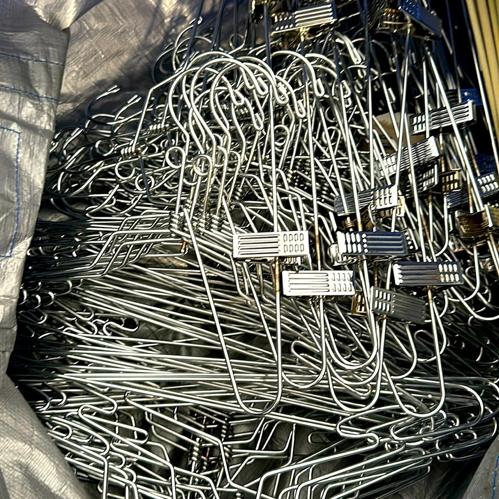 Metal hangers with and without pant clips… 3 huge bags full value $3,000
